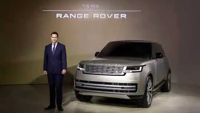 man standing in front of range rover